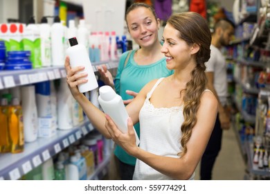 Positive American Girl Buying Shampoo In Shopping Mall
