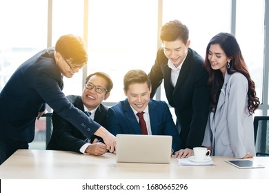 Positive Asian Business Team Having Meeting In Office