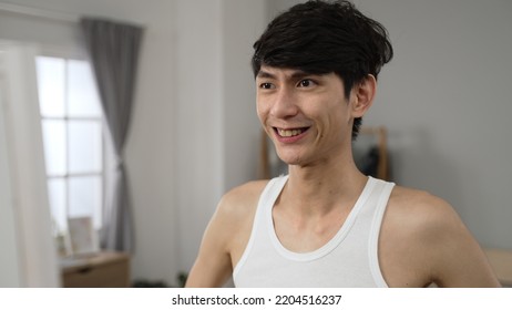 Positive Asian Japanese Man Patting His Face And Giving Pep Talk To His Reflection In The Mirror With Hand Gestures Before Important Meeting In The Morning At Home.