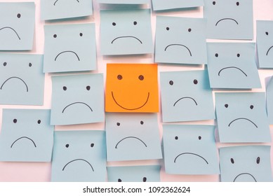 Positive Attitude and Happy Concept. Hand Drawn A Smile Face And Sad Emotion on Sticky Note Background. - Shutterstock ID 1092362624