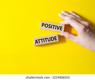 Positive Attitude Symbol. Concept Words Positive Attitude On Wooden Blocks. Beautiful Yellow Background. Businessman Hand. Business And Positive Attitude Concept. Copy Space.