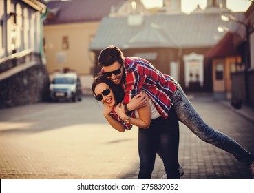 Positive And Carefree Couple Having Fun In City