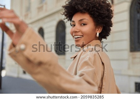 Similar – Woman Walking Through Building