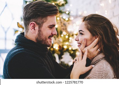 Positive caucasian couple with cute smiles feeling pleasure from spending time togetherness looking to each other with love in eyes during leisure time, concept of family relationship and happiness