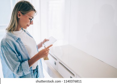 Positive Caucasian Young Woman Holding Received Envelope Checking Mail From Metal Letterbox In Apartment,pretty Caucasian Hipster Girl In Spectacles Reading Correspondence From Postal Delivery