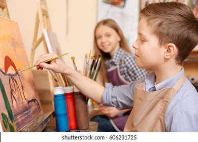 Positive children painting at the art class
