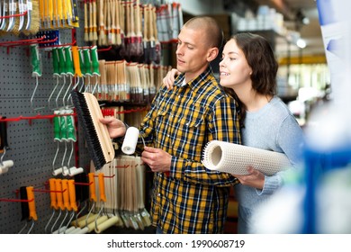 Positive Couple Choosing Supplies For Home Renovation In Store Of Building Materials