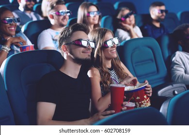 Positive Couple Drinking Cola And Eating Popcorn In Cinema.