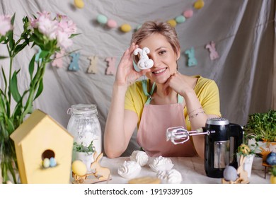 A Positive Culinary Specialist Makes Meringues. Marshmallow Cooking Process. Easter Festive Dinner Table. Womens Day Mother In The Kitchen At Home. Small Business Confectionery Chef. Funny Sweets