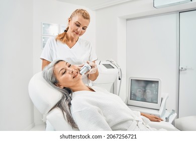 Positive delighted longhaired woman being in beauty clinic