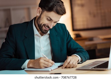 Positive Delighted Male Person Writing Notes