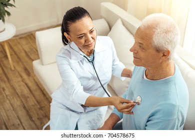 Positive Delighted Nurse Sitting With Her Patient