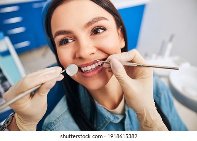 Positive Delighted Woman Sitting In Cabinet Of Her Dentist While Doing Checkup