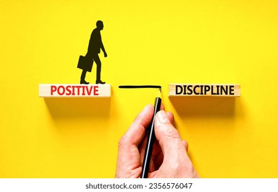 Positive discipline symbol. Concept words Positive discipline on beautiful wooden blocks. Beautiful yellow background. Businessman hand. Business psychology positive discipline concept. Copy space.