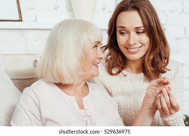 Positive Elderly Woman Taking Pill