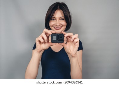 Positive emotions from photography . Woman with camera.  Gopro. Action camera - Powered by Shutterstock