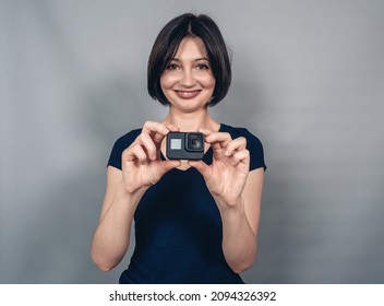 Positive emotions from photography . Woman with camera.  Gopro. Action camera - Powered by Shutterstock