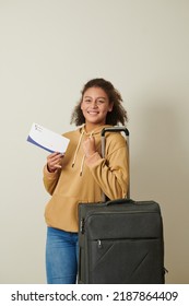 Positive Excited College Girl With Suitcase Showing Acceptance Letter