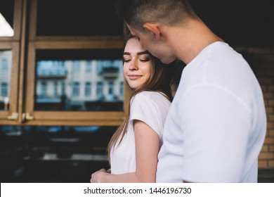 Positive family marriage enjoying free time togetherness standing at urban setting and hugging, Caucasian married pair adoring each other flirting outdoors, dearness man and woman embracing