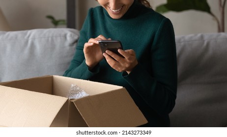 Positive Feedback. Close Up Of Young Woman Leaving Comment At Web Store Site After Receiving Parcel With Goods Purchased. Smiling Millennial Female Order Consumer Products Delivery Online Using Phone