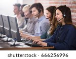 Positive Female Customer Services Agent With Headset Working In A Call Center