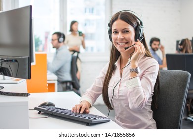 Positive Female Customer Services Agent With Headset Working In Call Center