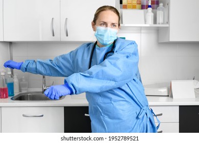 Positive Female Doctor Dancing Floss Dance In Hospital, Celebrating The End Of Coronavirus Pandemic. High Quality Photo.