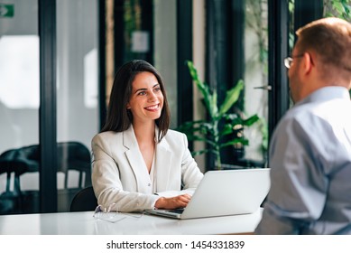 Positive Female Financial Advisor On A Meeting With A Client.