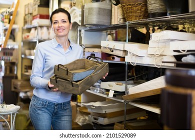 Positive Female Holding Boxes For Her House In A Modern Home Decor Store