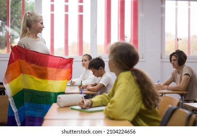 Positive Female Teacher Explaining Lgbt Theme To Children During Lesson In Class In Secondary School