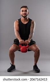 Positive Fit Young Man Doing Deep Squats With Heavy Weight