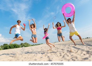 Positive Friends Having Fun On The Beach