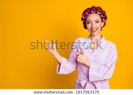 Positive girl point index finger copyspace spa salon adverts promotion wear bath robe isolated shine color background