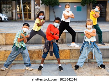 Positive Girls And Boys In Face Masks Training Hip Hop On City Street, Outdoor Dance Class For Kids At Pandemic Situation