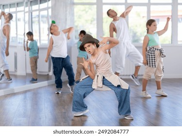 Positive girls and boys training hip hop in dance studio, dance classes for kids - Powered by Shutterstock