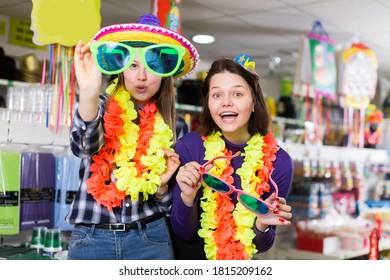 Positive Girls Shopping Together, Looking For Funny Things In Store Of Festival Outfits And Accessories