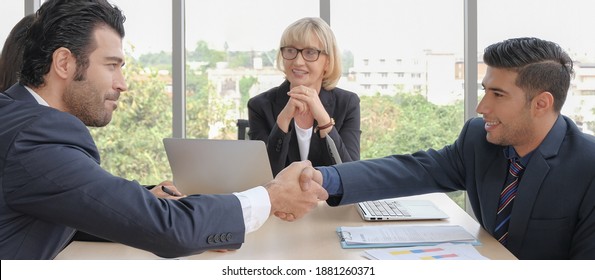 Positive handshaking people in small group business meeting concept. - Shutterstock ID 1881260371