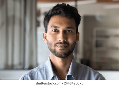 Positive handsome young Indian man head shot front portrait. Successful entrepreneur, startup leader, project manager, business professional in casual looking at camera - Powered by Shutterstock