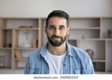 Positive handsome young Latin entrepreneur man standing for head shot. Front portrait of successful business owner in casual cloth, businessman, professional, manager looking at camera - Powered by Shutterstock