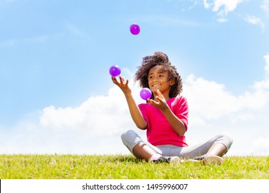 Positive Happy Girl Juggle Balls On The Grass