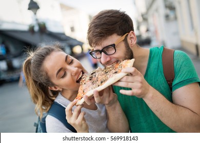 Positive Happy Students Eating Pizza On Street