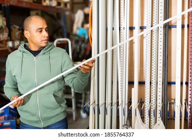 Positive Hispanic Man Looking For Construction Supplies For Renovation Works In Building Hypermarket