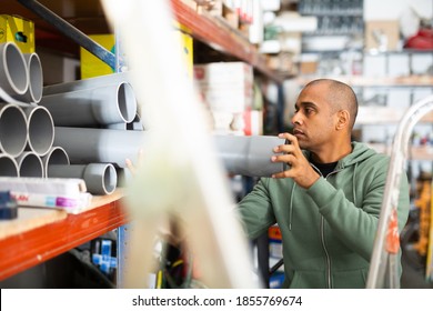 Positive Hispanic Man Looking For Construction Supplies For Renovation Works In Building Hypermarket