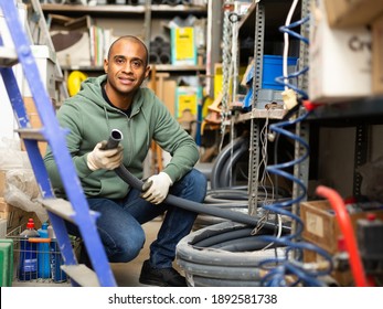 Positive Hispanic Man Looking For Construction Supplies For Renovation Works In Building Hypermarket