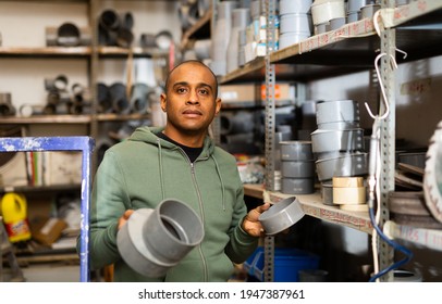 Positive Hispanic Man Looking For Construction Supplies For Renovation Works In Building Hypermarket