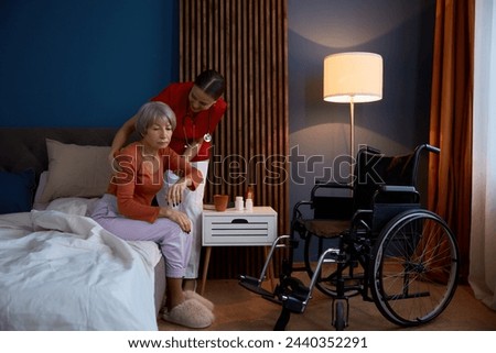 Similar – Caregiver with elderly patient in a wheelchair in front of window