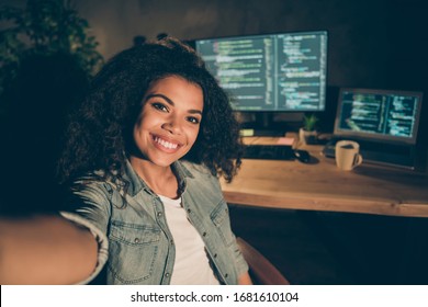 Positive joyful afro american girl web designer sit late evening office make self portrait show her java script data administrator work table desk computer in workstation workplace