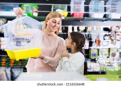 Positive Kid Girl Begging Her Mother To Buy Bird Cage At Pet Store