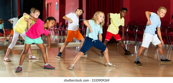 Positive Kids Studying Modern Style Dances In Dance Class Indoors