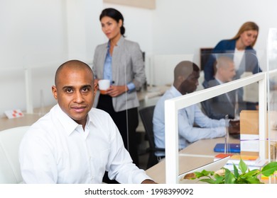 Positive Latino Male Manager In White Office